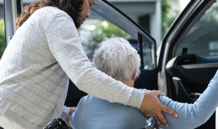 Support worker providing transport support with NDIS participant