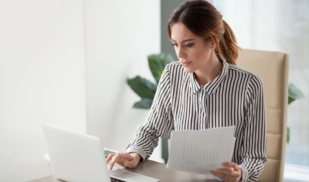 Professional Female Support Coordinator Reviewing Ndis Support Coordination Funding Paperwork At Her Desk