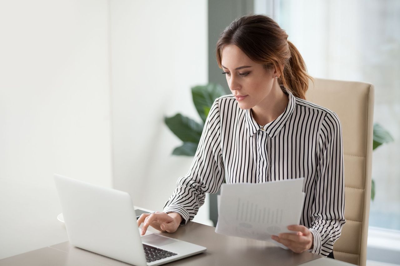 Professional Female Support Coordinator Reviewing Ndis Support Coordination Funding Paperwork At Her Desk