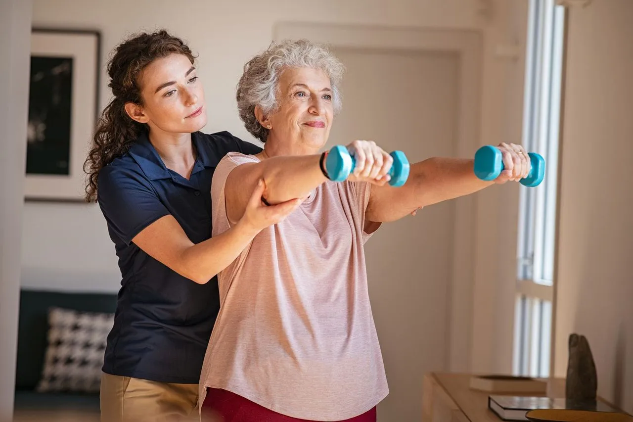 Exercise Phsiologist Working With Elderly Woman